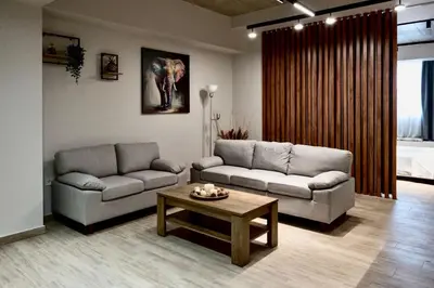 a living room with two couches and a coffee table at African Adventure Apartment in Piraeus