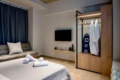 a hotel room with a bed and a couch at African Adventure Apartment in Piraeus