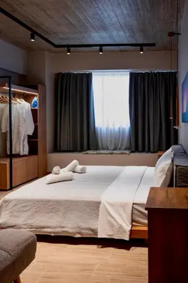 a bedroom with a bed with two towels on it at African Adventure Apartment in Piraeus