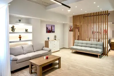 a living room with a couch and a table at Big London Apartment in Piraeus in Piraeus