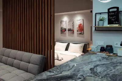 a living room with a bed and a couch at Big London Apartment in Piraeus in Piraeus