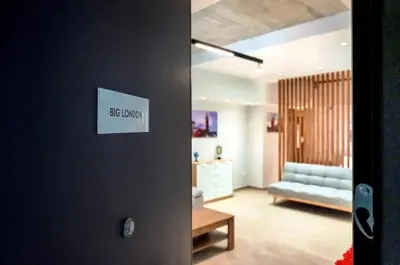 a living room with a couch and a table at Big London Apartment in Piraeus in Piraeus
