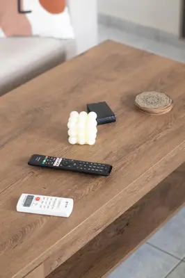 a table with two remotes and two remote controls at Airport city center 4 in Spáta