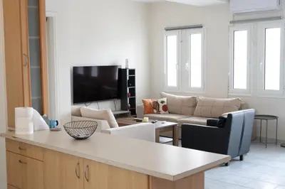 a living room with a couch and a tv at Airport city center 4 in Spáta