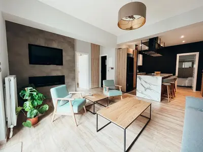 a living room with a table and chairs at Sunlit luxurious flat at pagrati! in Athens