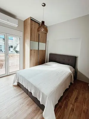 a bedroom with a large bed and a large window at Sunlit luxurious flat at pagrati! in Athens