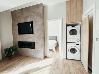 a laundry room with a washer and dryer at Sunlit luxurious flat at pagrati! in Athens
