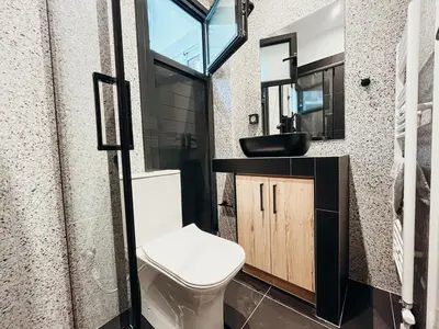 a bathroom with a toilet and a sink at Sunlit luxurious flat at pagrati! in Athens
