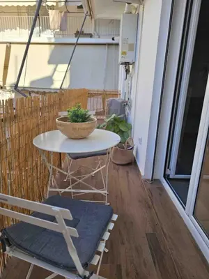 a small table and a chair on a balcony at Sunlit luxurious flat at pagrati! in Athens