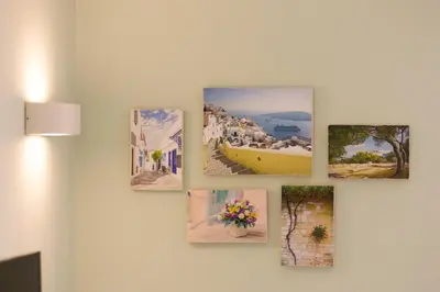 a group of pictures hanging on a wall at MORE Apartments in Áyios Yeóryios