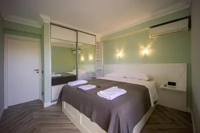 a bedroom with a large bed with towels on it at MORE Apartments in Áyios Yeóryios