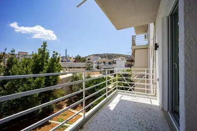 a balcony with a view of a city at MORE Apartments in Áyios Yeóryios