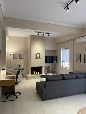 a living room with a couch and a fireplace at Kolonos Comfort Design Flat for Easy City Living in Athens