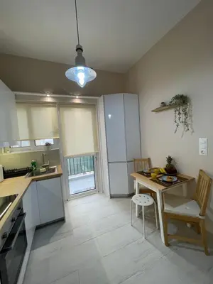 a kitchen with a table and chairs in a room at Kolonos Comfort Design Flat for Easy City Living in Athens
