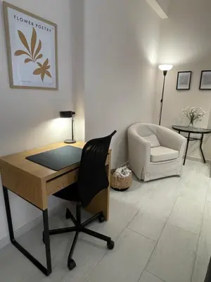 a office with a desk and a chair and a couch at Kolonos Comfort Design Flat for Easy City Living in Athens