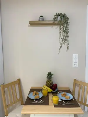 a table with plates of food and fruit on it at Kolonos Comfort Design Flat for Easy City Living in Athens