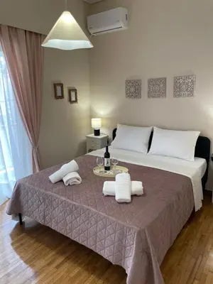 a bedroom with a bed with towels on a table at Kolonos Comfort Design Flat for Easy City Living in Athens