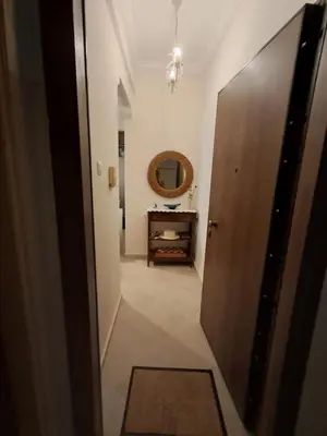 a hallway with a door and a dresser and a mirror at Reina in Athens