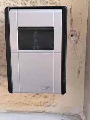 a switch on the side of a wall at Reina in Athens