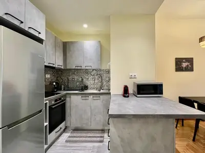 a kitchen with stainless steel appliances and a counter top at Home away from home in Athens