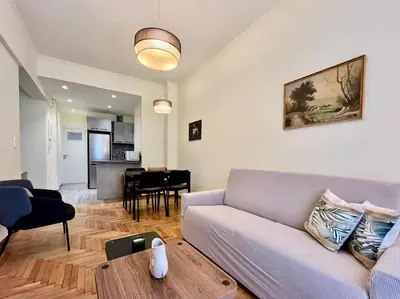 a living room with a couch and a table at Home away from home in Athens