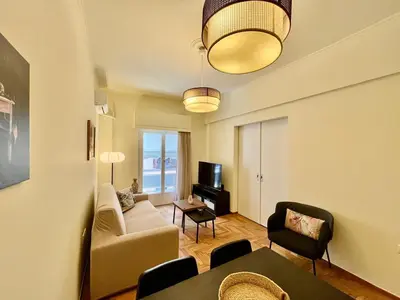 a living room with a couch and a table at Home away from home in Athens