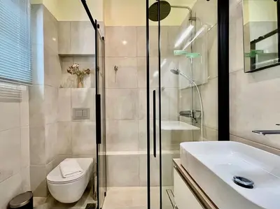 a bathroom with a shower and a toilet and a sink at Home away from home in Athens