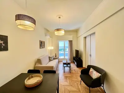 a living room with a couch and a table at Home away from home in Athens