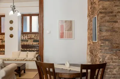 a dining room with a table and a couch at The Psyri Collection in Athens