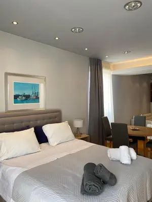 a bedroom with a bed with towels on it at Ermou 44 - Studio - Acropolis view in Athens