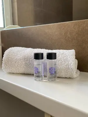 two bottles ofodorizers sitting on a shelf in a bathroom at Ermou 44 - Studio - Acropolis view in Athens