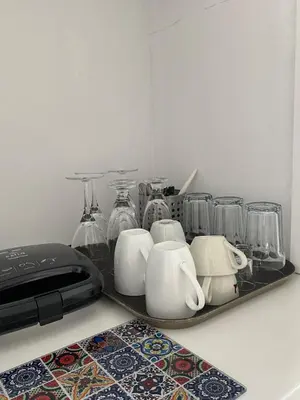 a tray with cups and glasses on a counter at Ermou 44 - Studio - Acropolis view in Athens