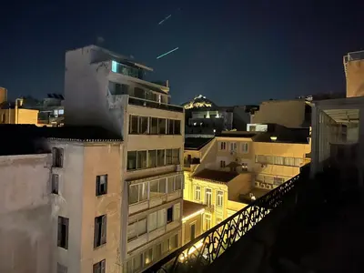 a view of a building at night at Ermou 44 - Studio - Acropolis view in Athens