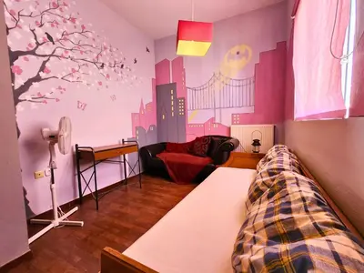 a bedroom with a bed and a city mural on the wall at Roof Garden Loft in Athens