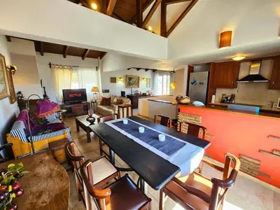a large living room with a large table and chairs at Roof Garden Loft in Athens