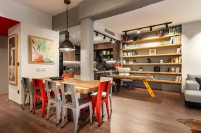 a kitchen and dining room with a wooden table and chairs at The Architect s Loft in Athens