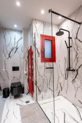 a bathroom with a wall covered in marble at The Architect s Loft in Athens