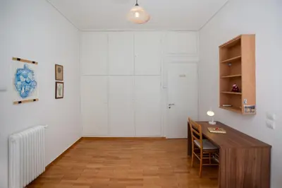 a white room with a desk and a white wall at Comfy Apartment In Exarchia Vibrant Neighborhood in Athens