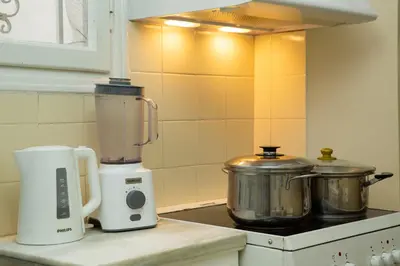 a kitchen with a blender and a pot on a counter at Comfy Apartment In Exarchia Vibrant Neighborhood in Athens