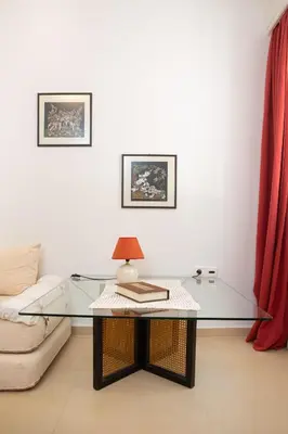 a living room with a glass table and a couch at Cute Retro Apartment In Exarchia Neighborhood in Athens
