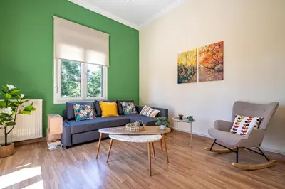 a living room with a couch and a table at Monastiraki Aélia Apartment by ΜΡS in Athens