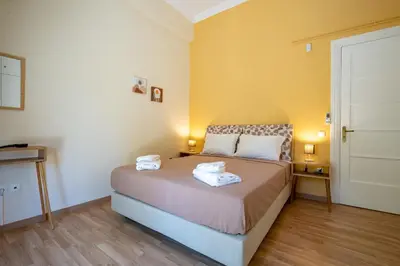 a bedroom with a bed with two towels on it at Monastiraki Aélia Apartment by ΜΡS in Athens