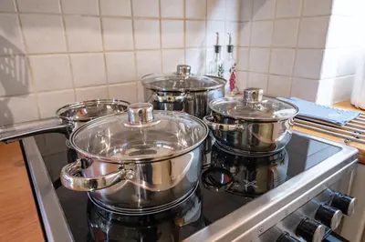 a group of four pots sitting on top of a stove at Monastiraki Aélia Apartment by ΜΡS in Athens