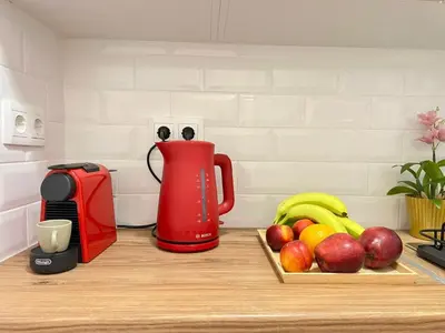 a counter with a red pitcher and a tray of fruit at Bright and stylish Acropolis studio in Athens