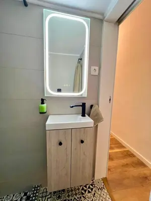 a bathroom with a sink and a mirror at Bright and stylish Acropolis studio in Athens