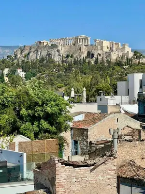 a view of the acropolis of athens from the roofs of buildings at Bright and stylish Acropolis studio in Athens