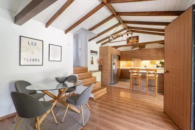 a kitchen and dining room with a glass table and chairs at Rustic Garden Cabin in Vari