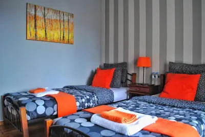 two beds in a room with orange and blue at Athens SmArt 3-Room Private Apartment in Athens