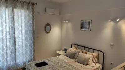 a bedroom with a bed and a window at Konstantinos Apartments in Athens
