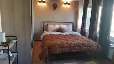a bedroom with a bed and a clock on the wall at Konstantinos Apartments in Athens